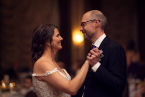a man wearing a suit and tie standing next to a woman