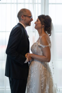 a man and a woman standing in front of a window